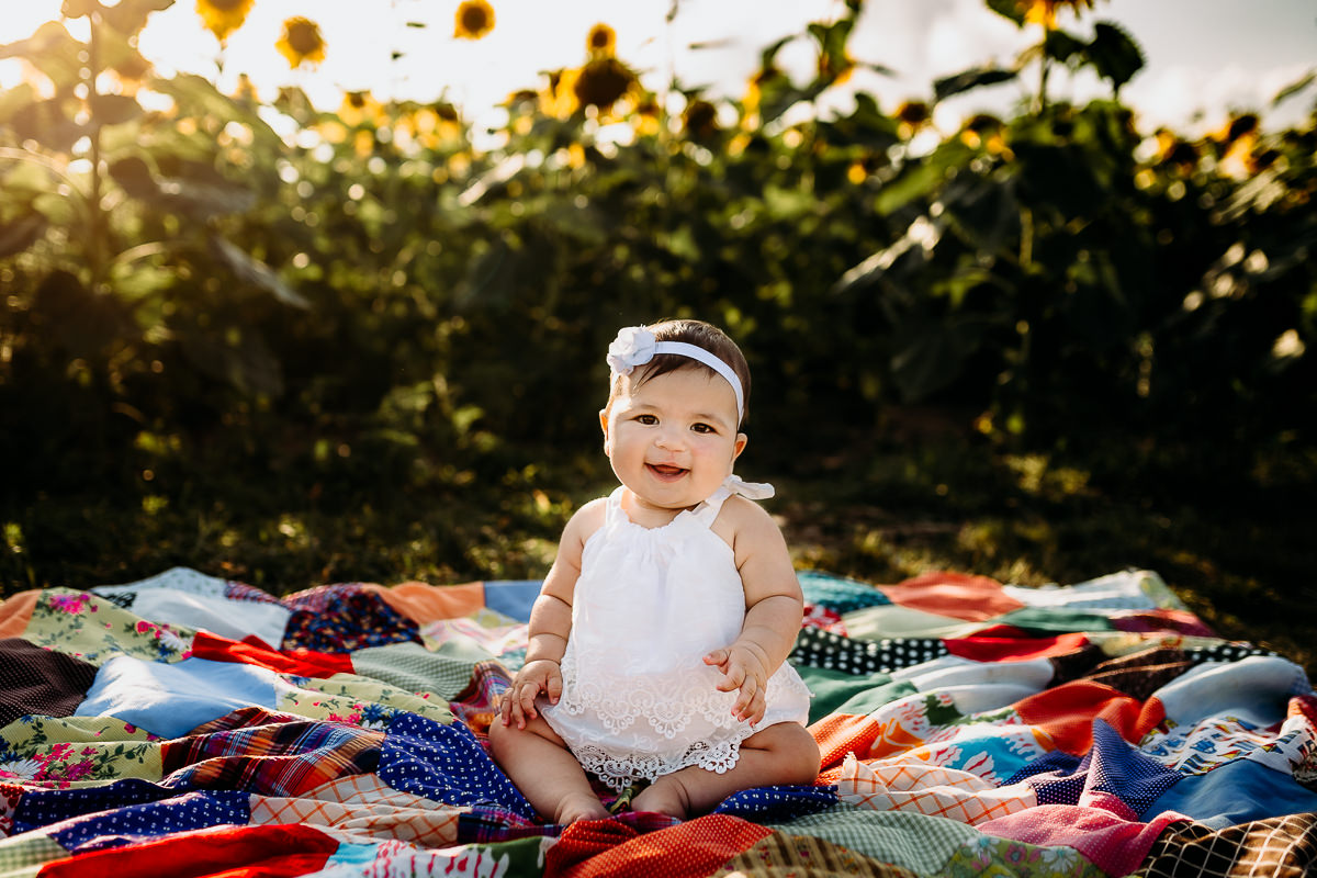 happy baby on bold quilt