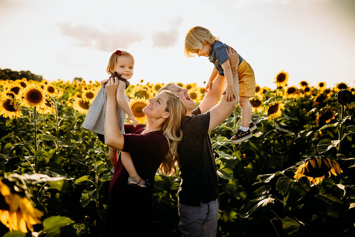 family having fun in the sunflower field