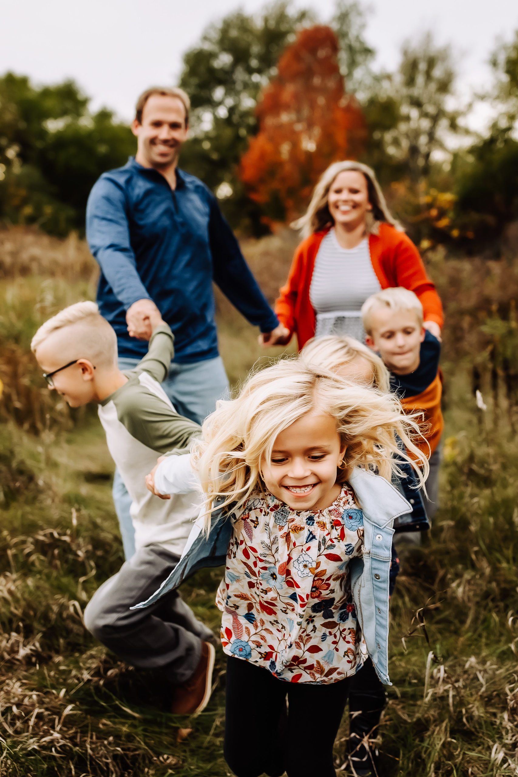 large family fall photo with kids running in madison wi